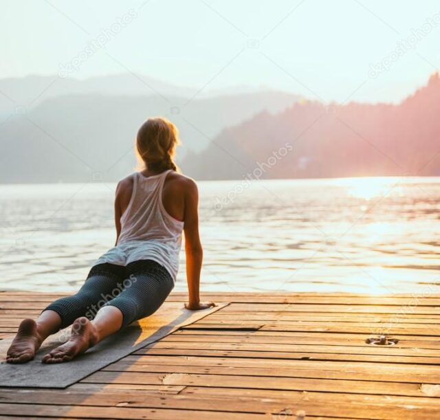 depositphotos_115158452-stock-photo-woman-practicing-yoga-by-the
